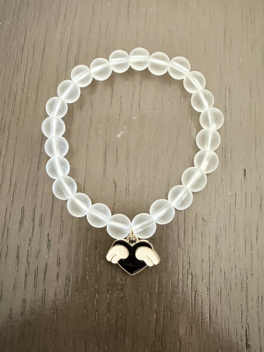 Frosted White Bead Bracelet with Black Heart Wing Charm